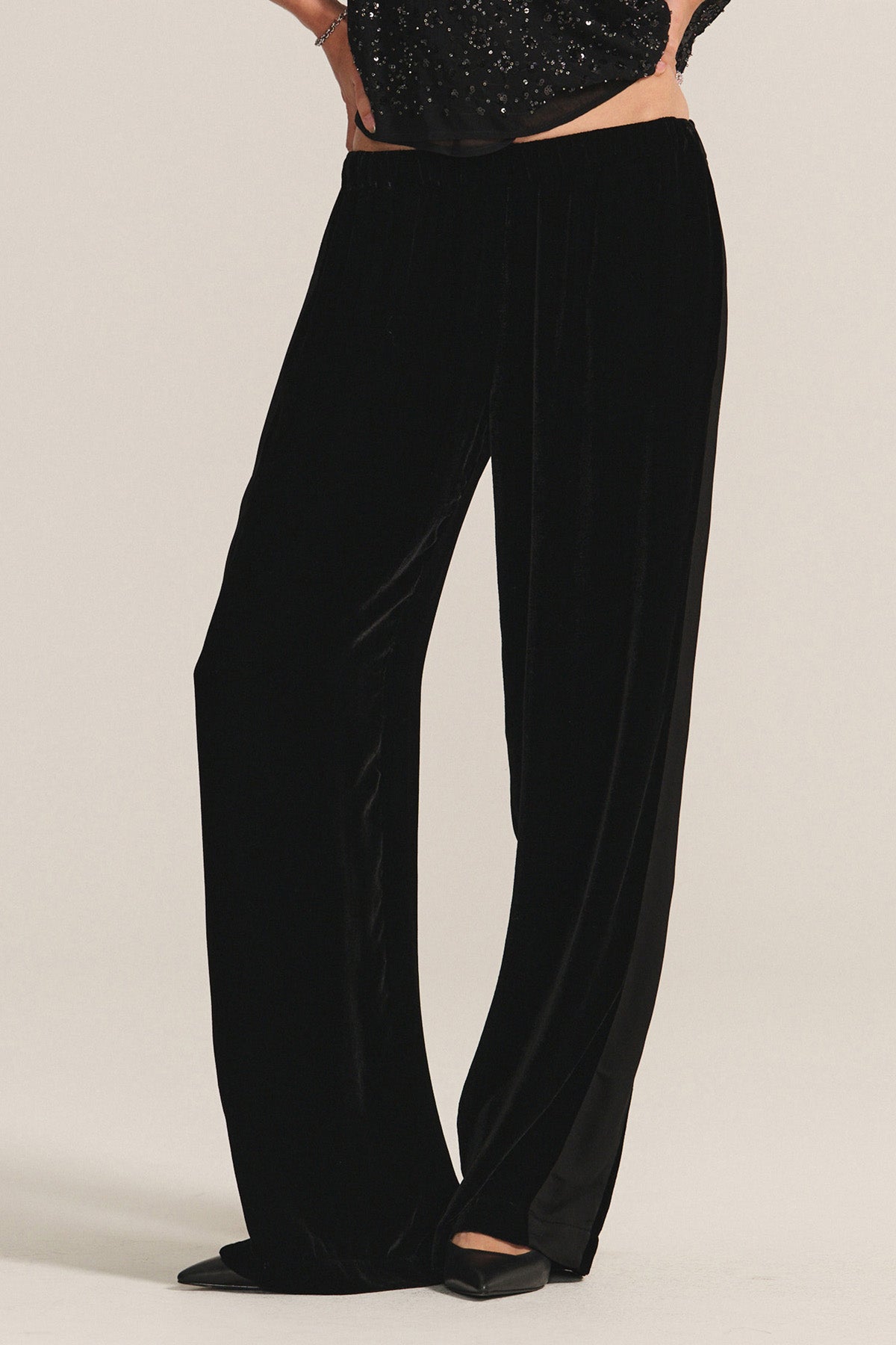 A person wearing the HILMA PANT by Velvet by Graham & Spencer and black pointed-toe shoes stands against a plain background.-40263649755329