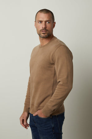 A man wearing a cozy Velvet by Graham & Spencer MATTS CREW NECK SWEATSHIRT to stay warm.