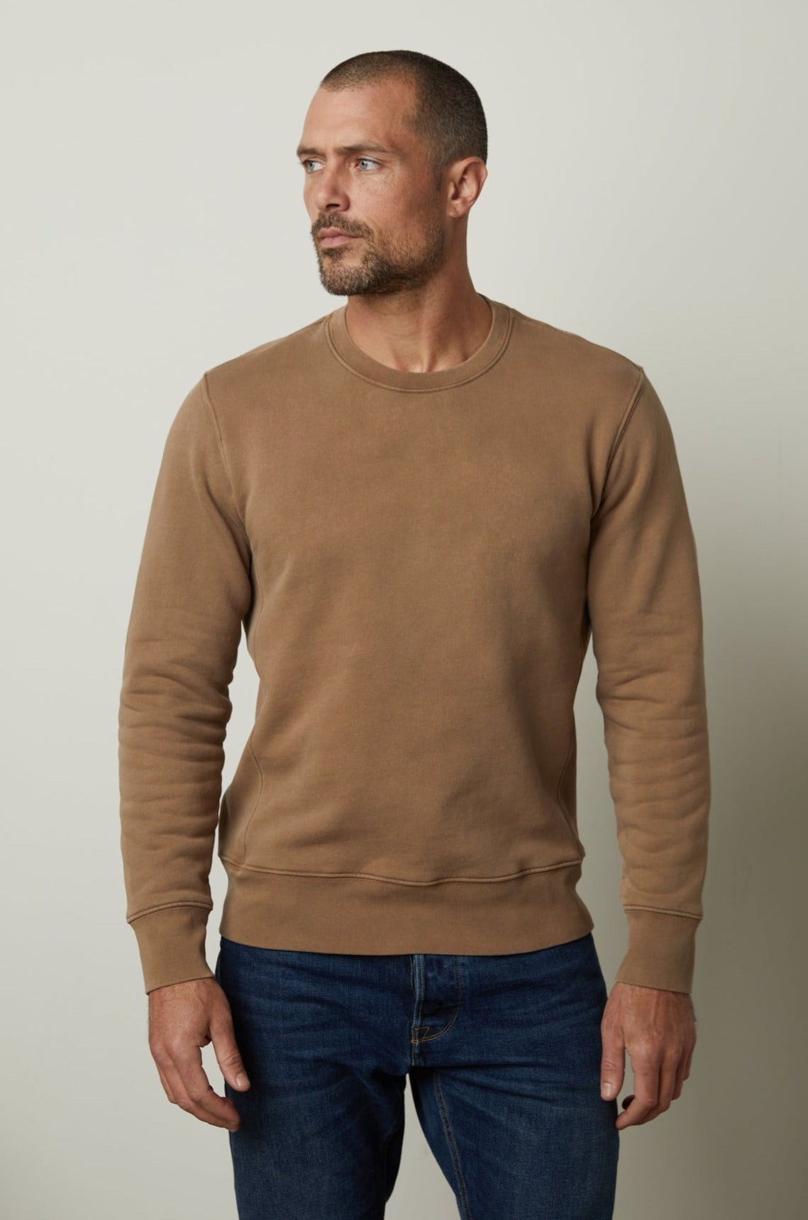   A man wearing a Velvet by Graham & Spencer MATTS CREW NECK SWEATSHIRT for comfort and warmth. 