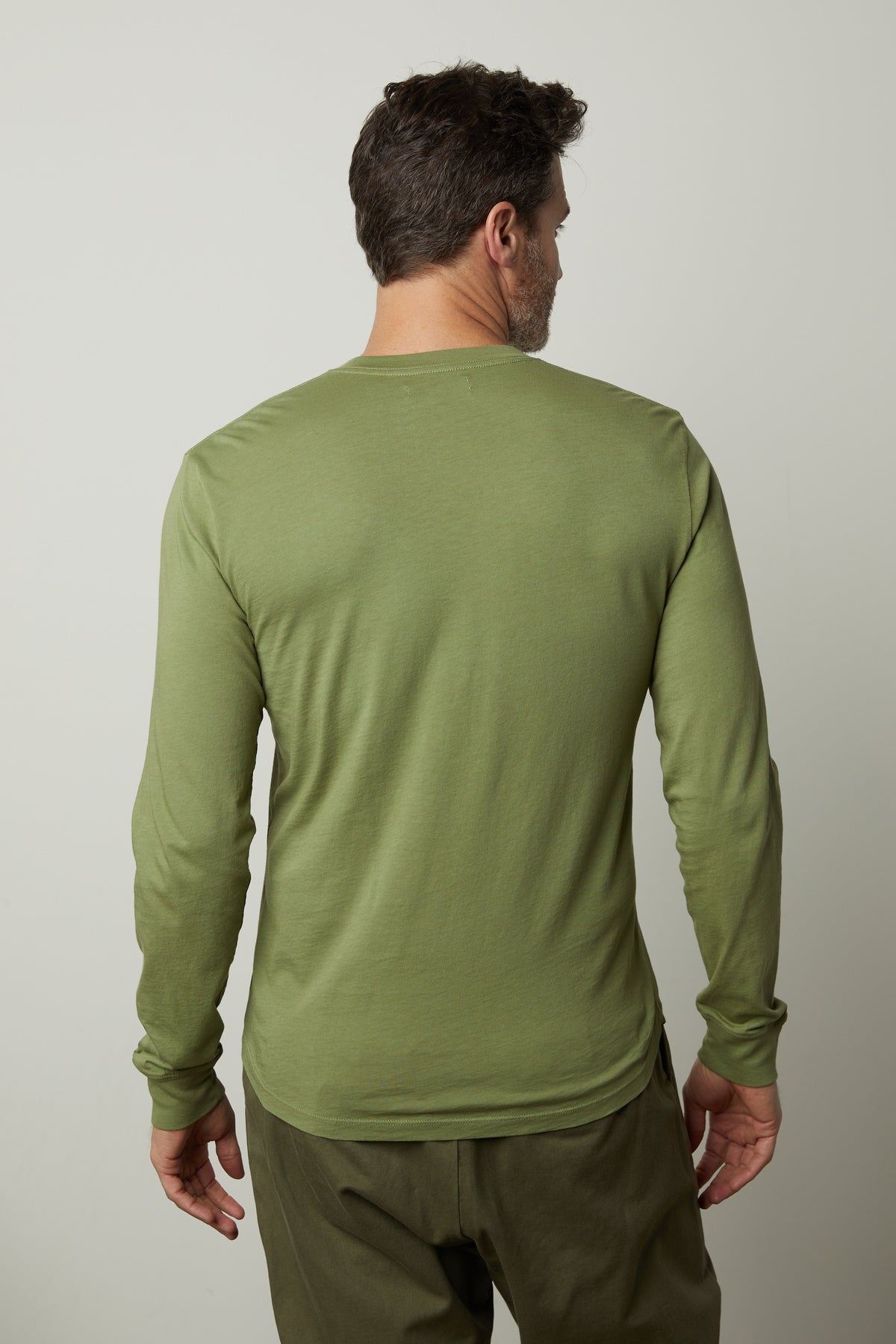 The back view of a man wearing a green BRADEN HENLEY long-sleeved shirt by Velvet by Graham & Spencer.-35567416737985