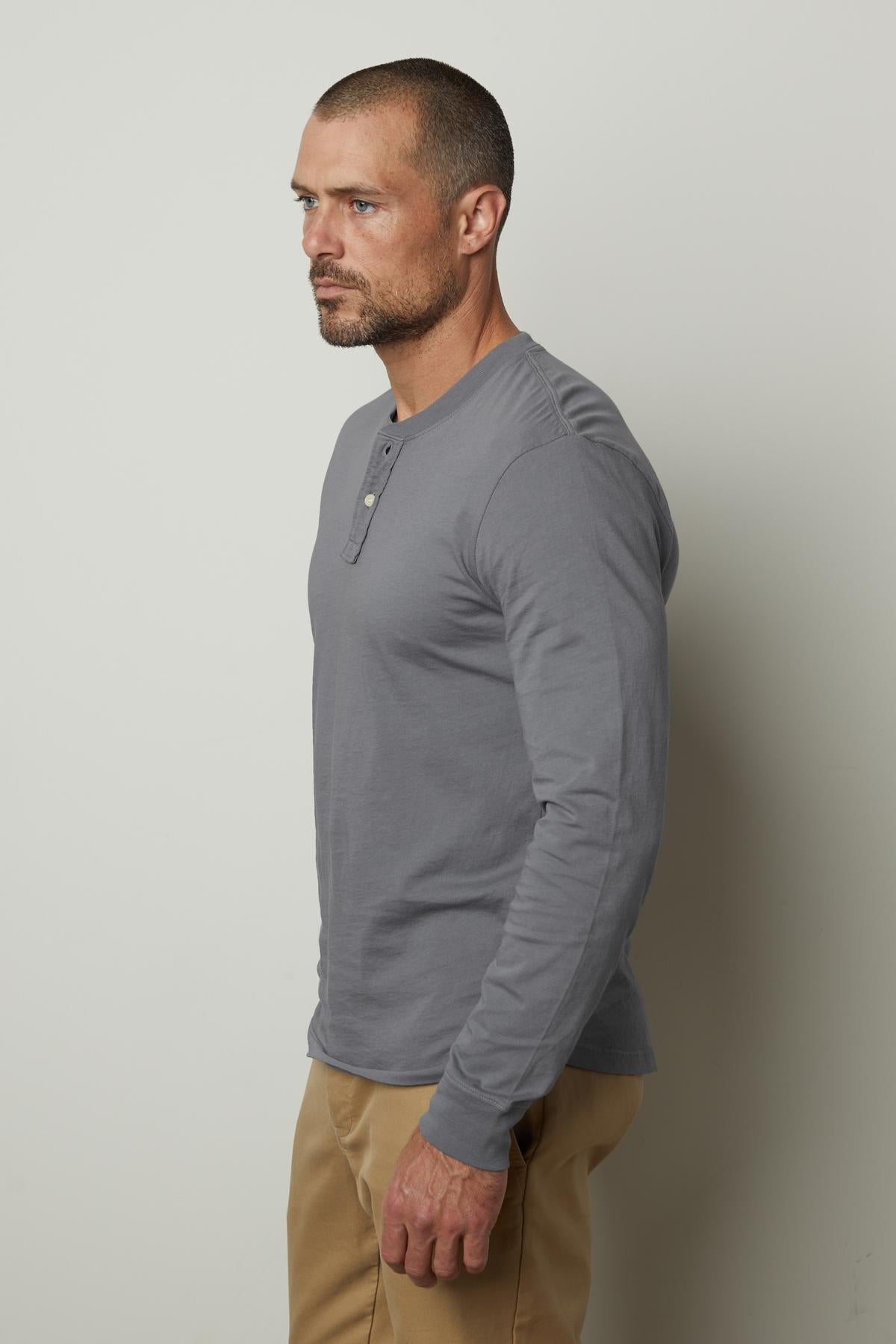 A man in a versatile gray Velvet by Graham & Spencer BRADEN HENLEY shirt and khaki pants.-35782157729985