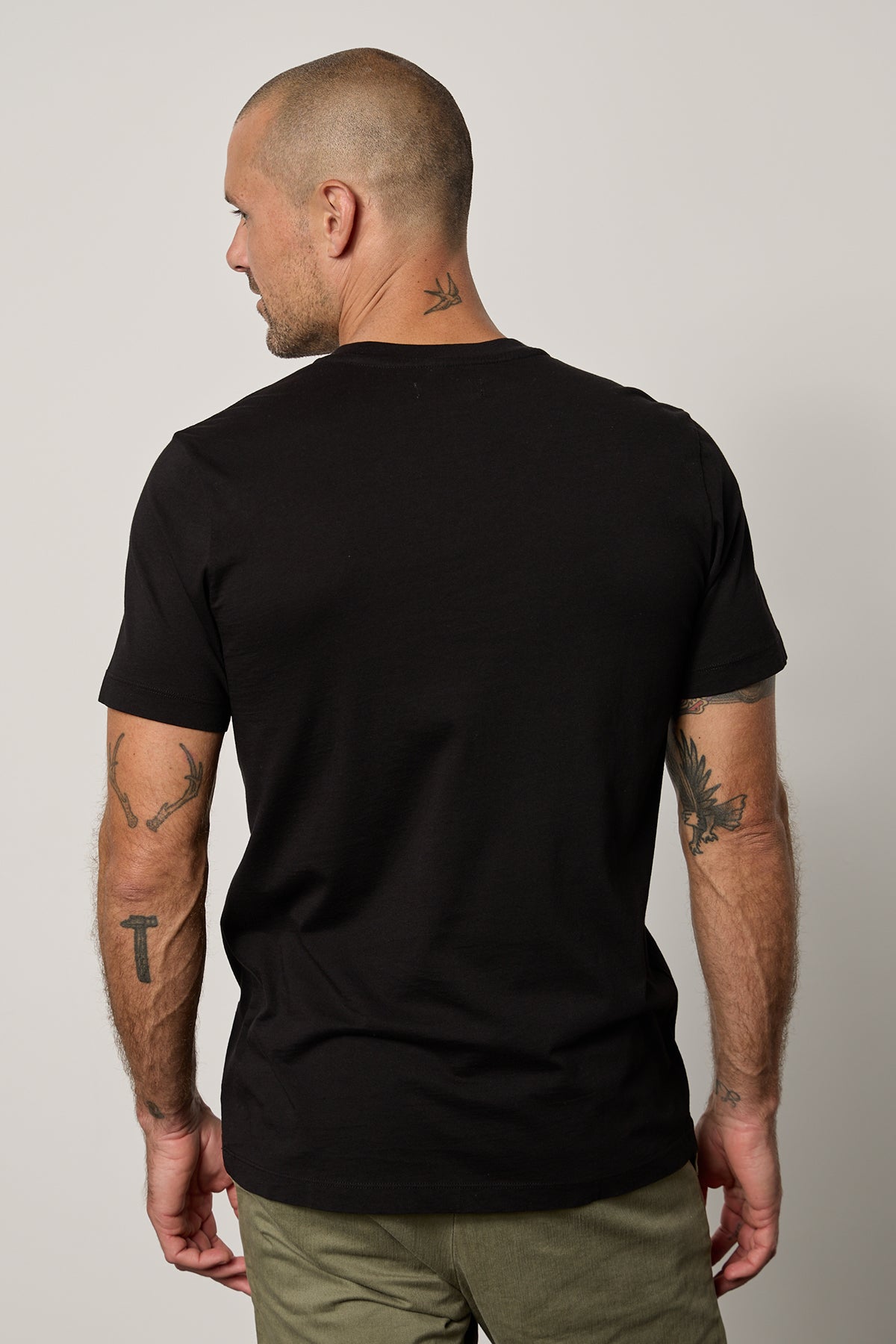   The back view of a man wearing a Velvet by Graham & Spencer MARSHALL V-NECK TEE. 