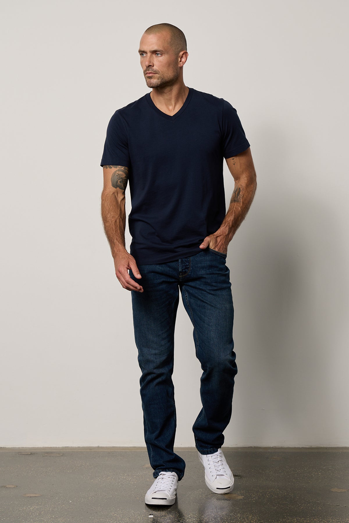   a man wearing jeans and a Velvet by Graham & Spencer MARSHALL V-NECK TEE. 