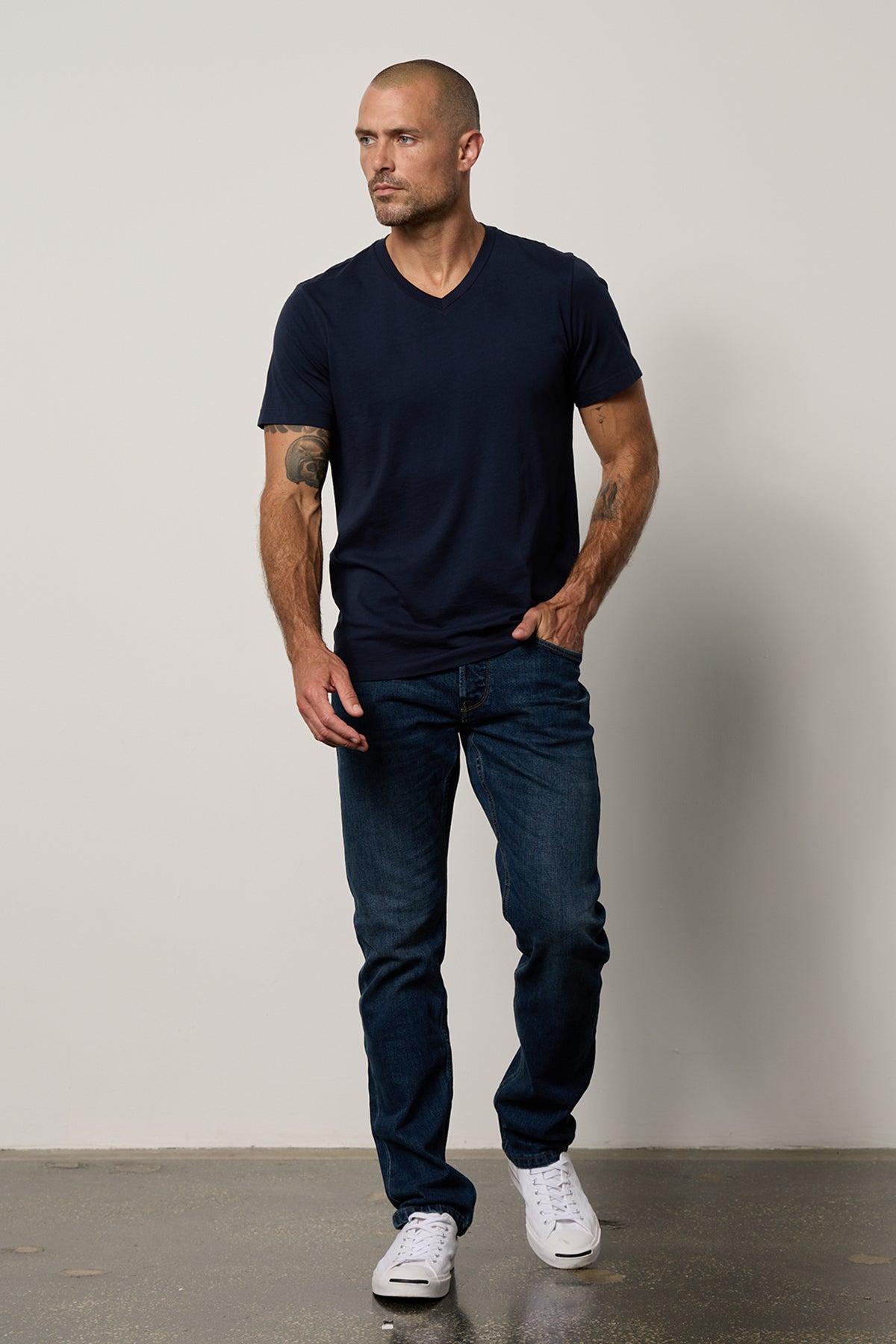 a man wearing jeans and a Velvet by Graham & Spencer MARSHALL V-NECK TEE.-26514079547585