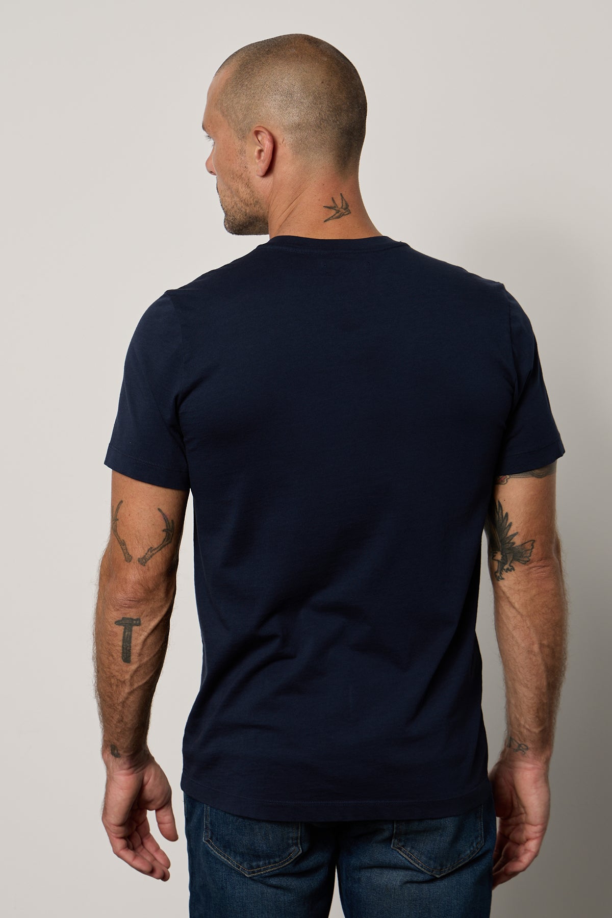   The back view of a man wearing a Velvet by Graham & Spencer MARSHALL V-NECK TEE. 
