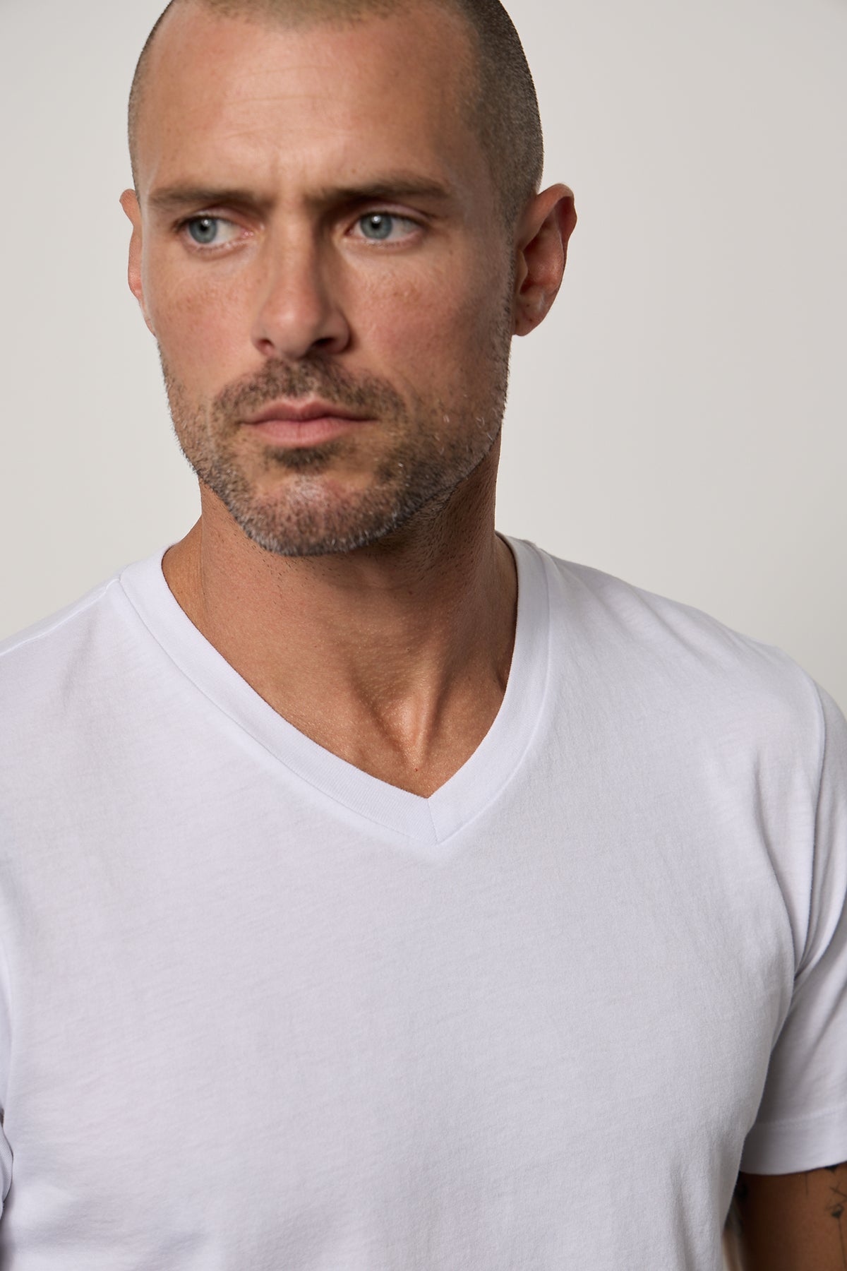   a man wearing a white Velvet by Graham & Spencer MARSHALL V-NECK TEE. 