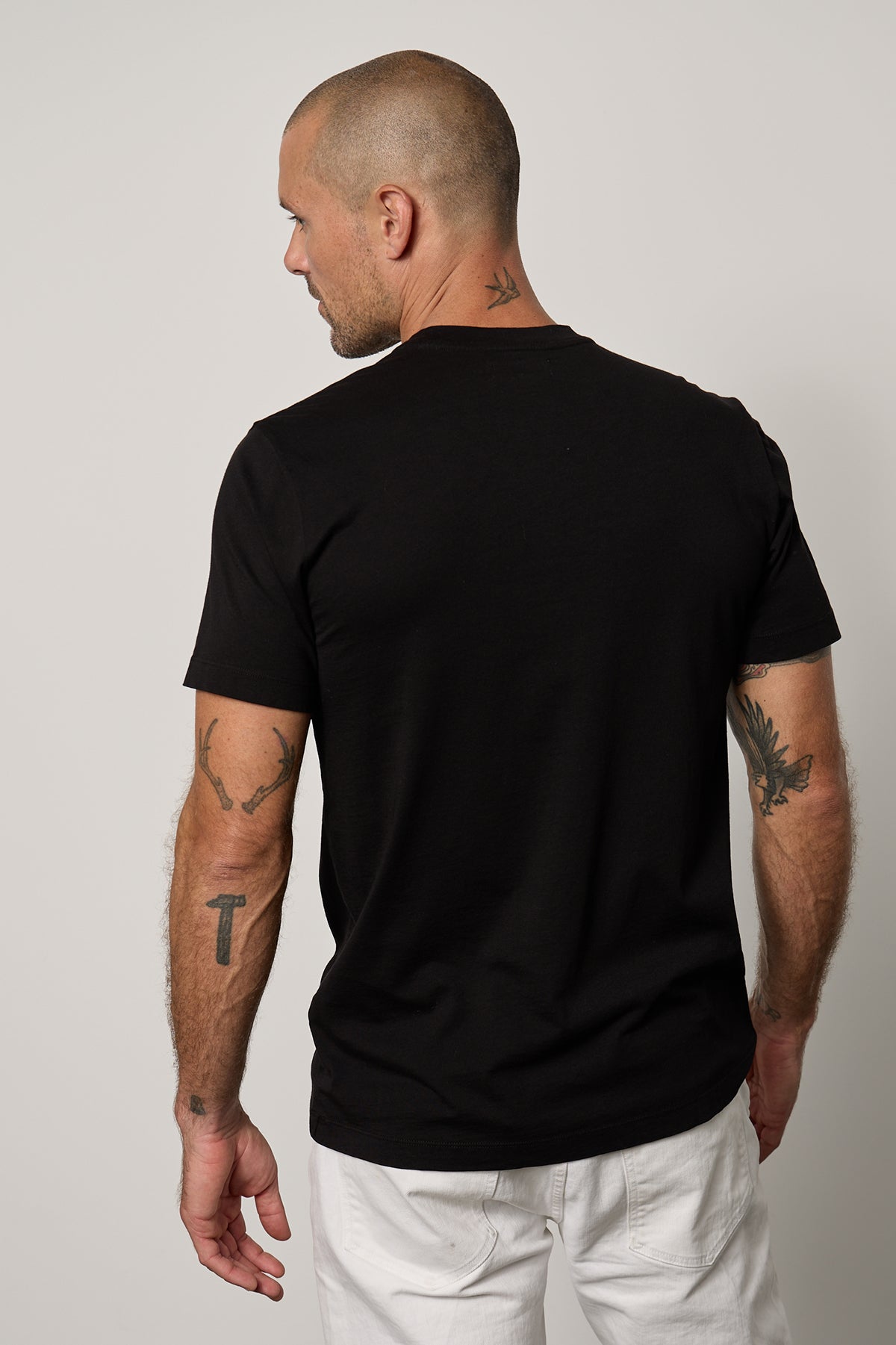 the back of a man wearing a Velvet by Graham & Spencer Randy Crew Neck Tee.-35755370479809