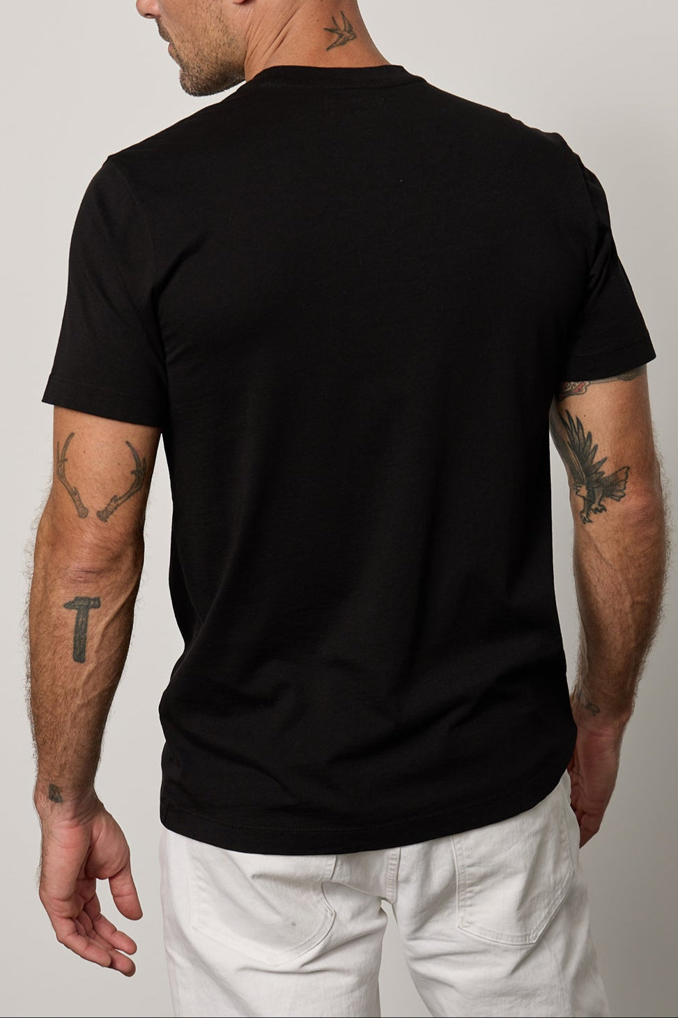 the back of a man wearing a Velvet by Graham & Spencer Randy Crew Neck Tee.-35755370479809