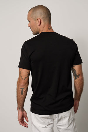 the back of a man wearing a Velvet by Graham & Spencer Randy Crew Neck Tee.