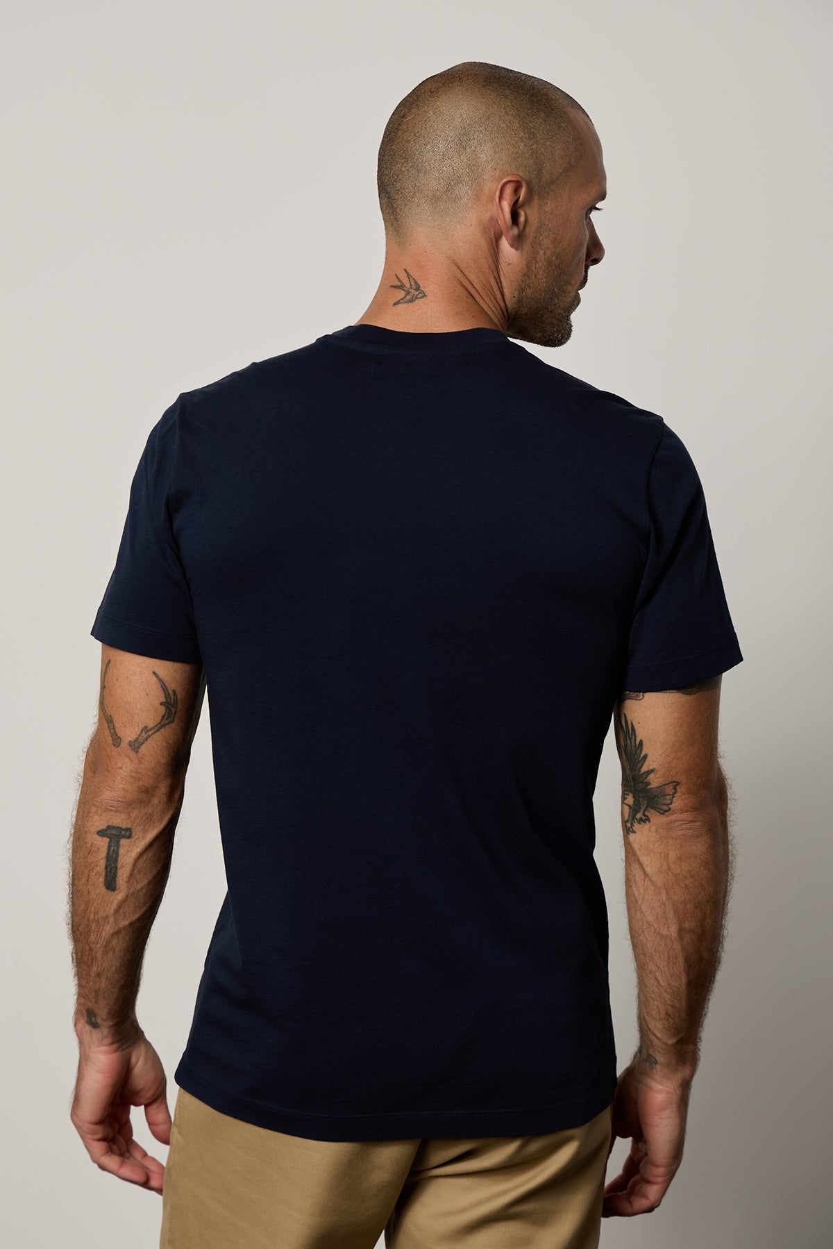the back view of a man wearing a Velvet by Graham & Spencer RANDY CREW NECK TEE.-35755370676417