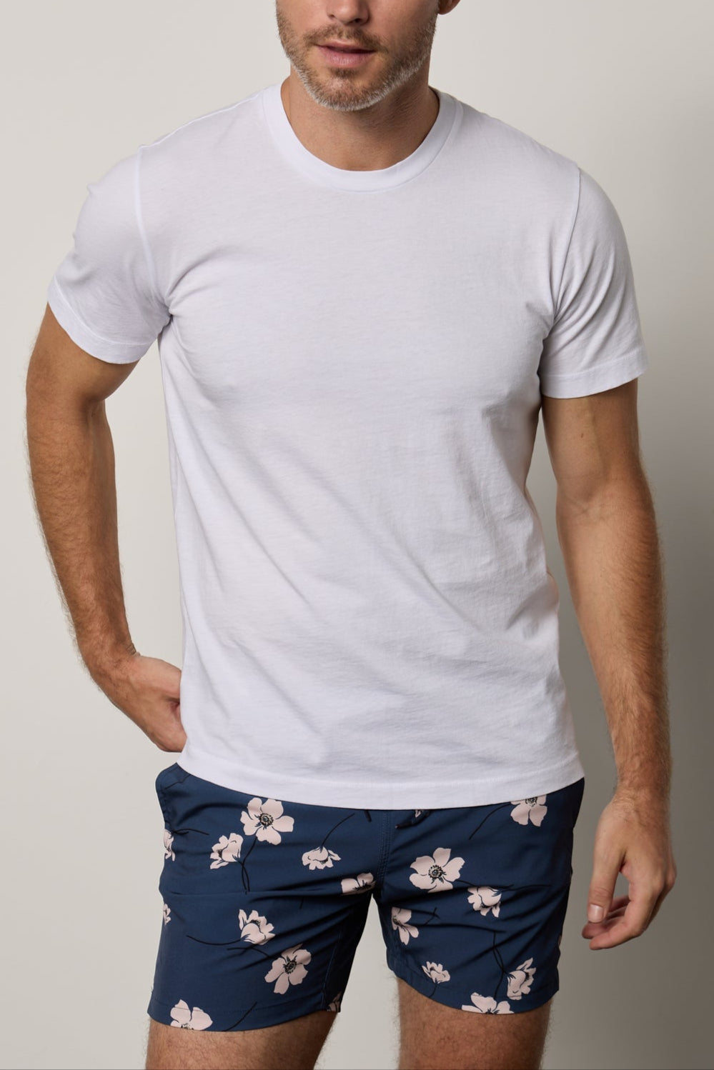 a man wearing a Velvet by Graham & Spencer RANDY CREW NECK TEE and blue floral shorts.-35755370774721