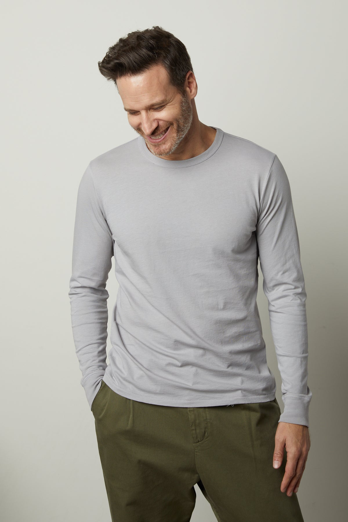 A man wearing a Velvet by Graham & Spencer STRAUSS CREW NECK TEE and green pants.-26846183096513