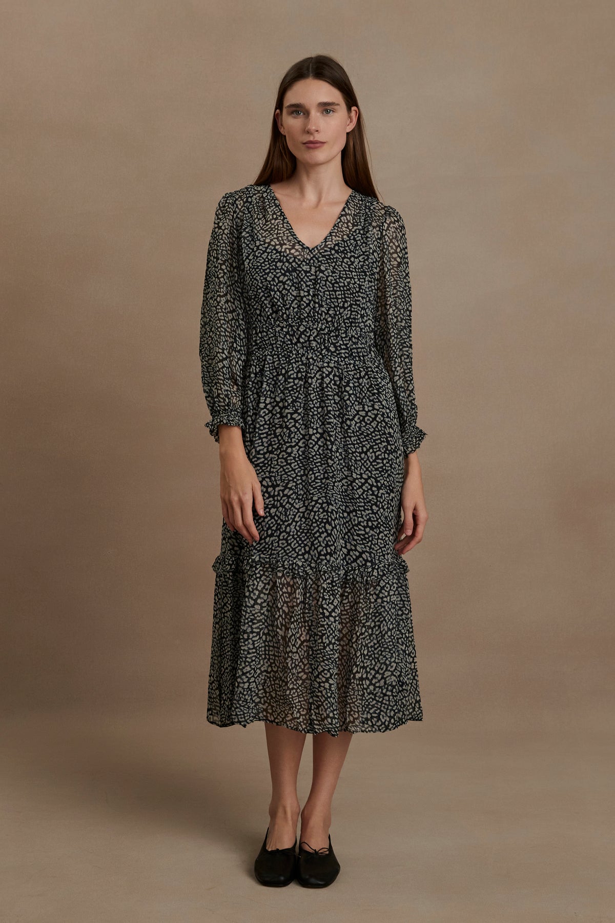 A woman wearing a Leslie Printed Boho Dress by Velvet by Graham & Spencer, which is a flared skirt midi dress with a lightweight viscose georgette overlay.-35630472102081