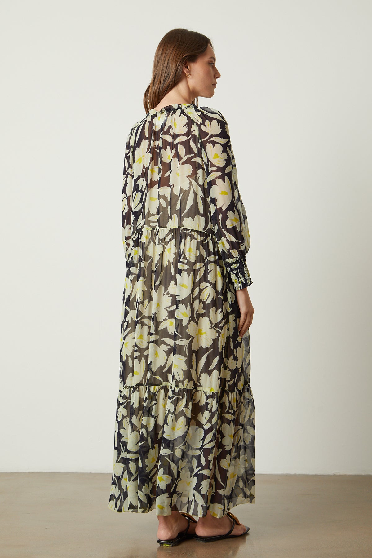   The back view of a woman wearing a Velvet by Graham & Spencer Serena Printed Maxi Dress. 