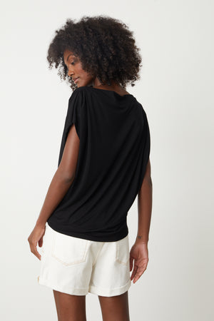 The back view of a woman wearing a Velvet by Graham & Spencer PAULINA VISCOSE JERSEY TOP and shorts.