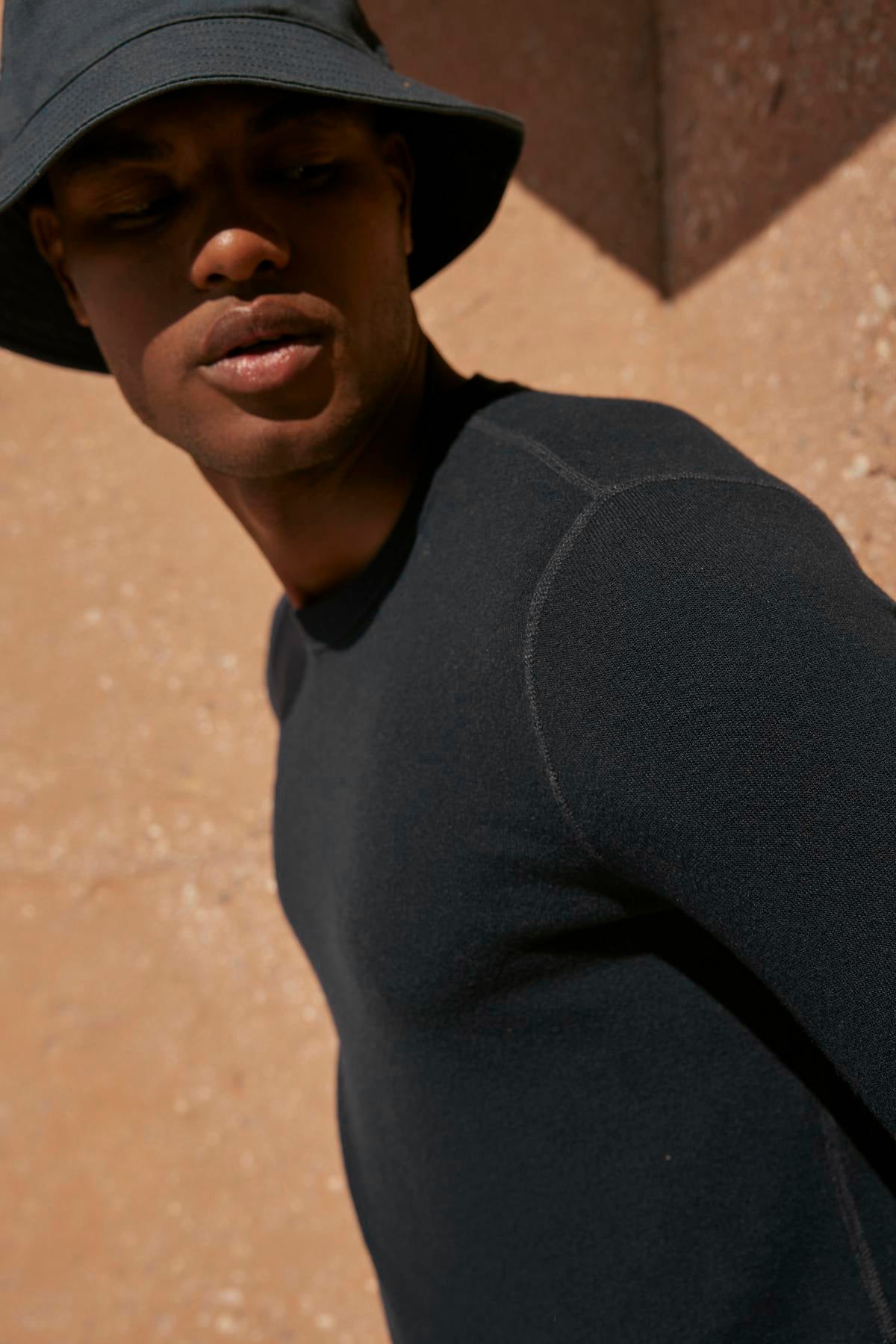   A man wearing a black hat and a Velvet by Graham & Spencer BECKER COZY JERSEY CREW. 