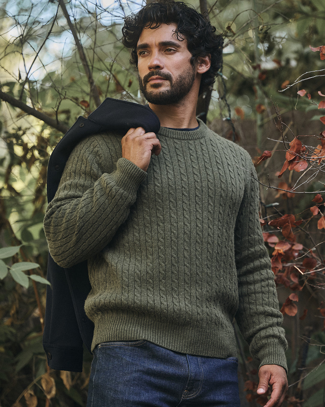 A man wearing the Alanzo Sweater in Locust by Velvet by Graham & Spencer.