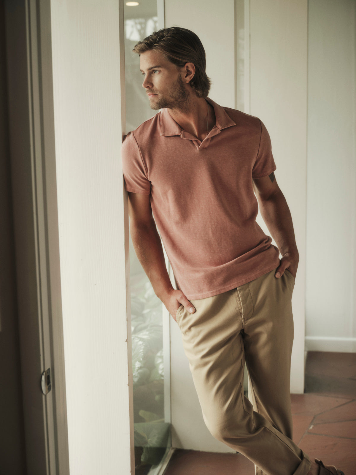   A man wearing a Velvet by Graham & Spencer Dilan Cotton Blend Polo shirt and khaki pants. 