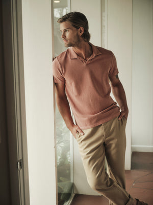 A man wearing a Velvet by Graham & Spencer Dilan Cotton Blend Polo shirt and khaki pants.