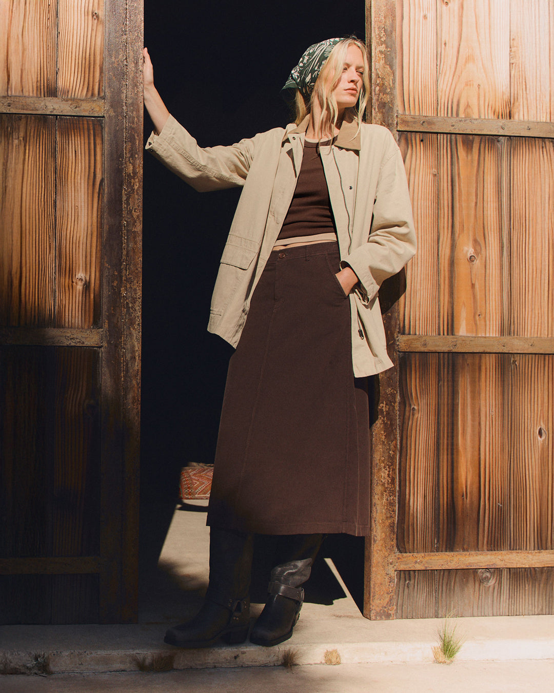 A woman wearing emerging from a building in Fia and Rosa by Velvet by Graham & Spencer.