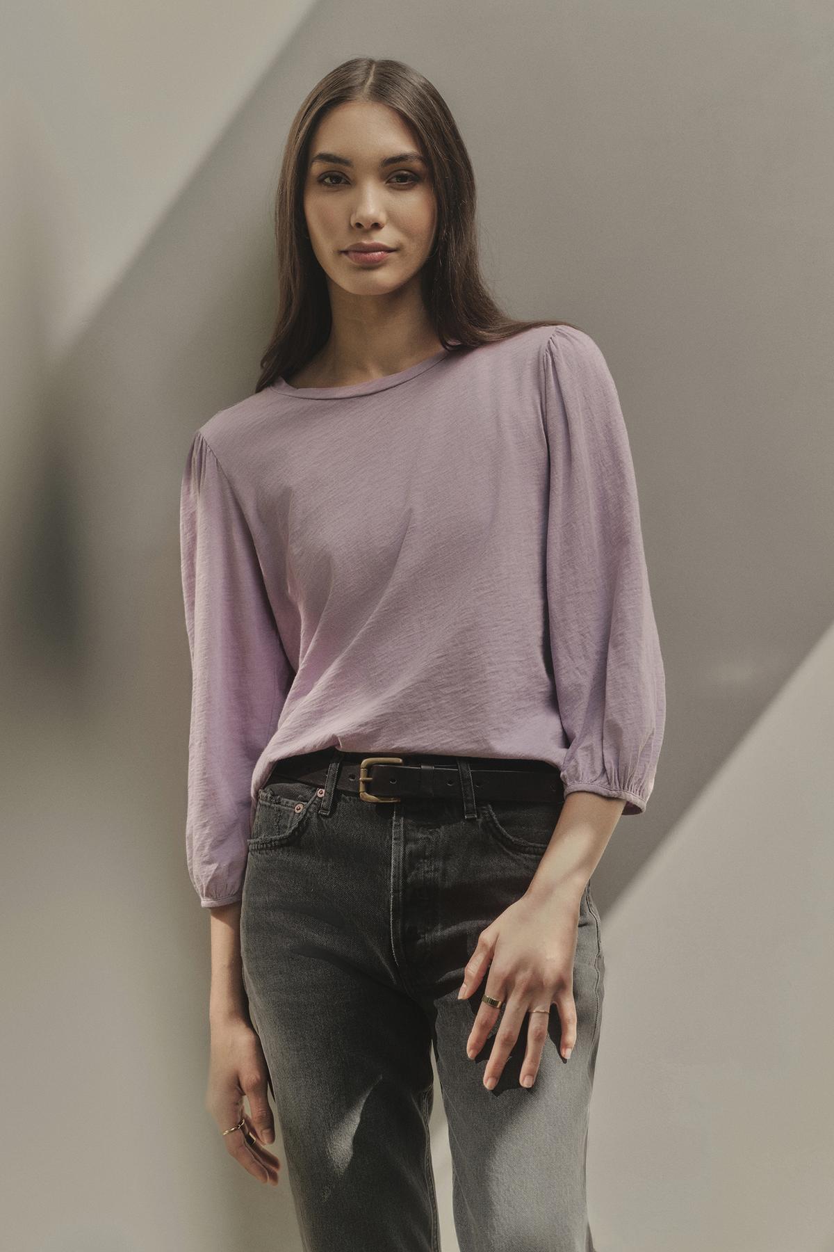   A woman wearing a Velvet by Graham & Spencer ANETTE PUFF SLEEVE TEE. 