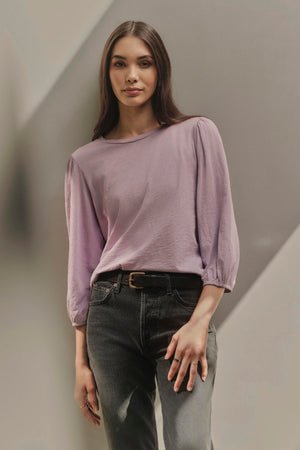 A woman wearing a Velvet by Graham & Spencer ANETTE PUFF SLEEVE TEE.