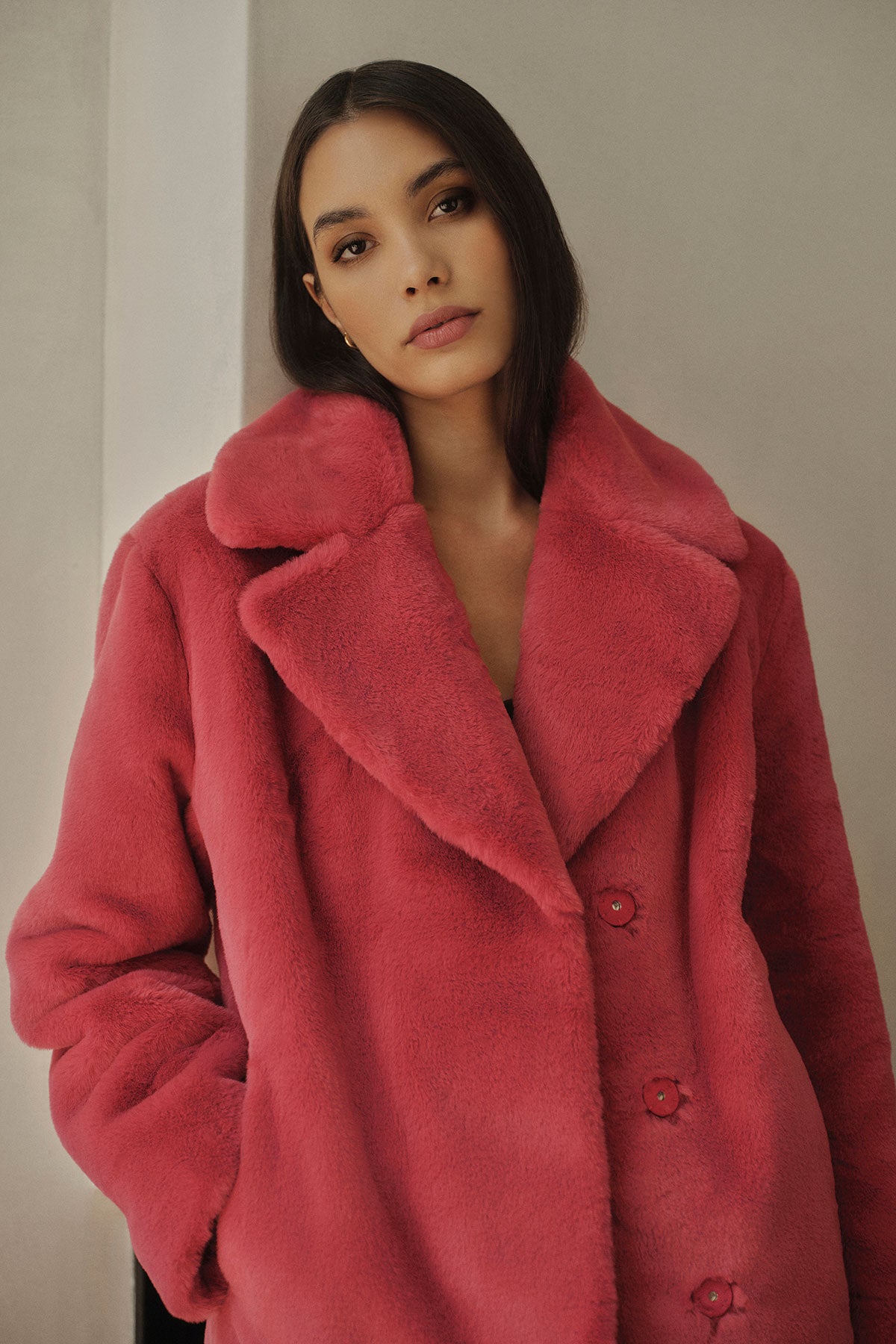 A chic model wearing a cozy pink Velvet by Graham & Spencer RAQUEL FAUX LUX FUR JACKET.-35446667280577