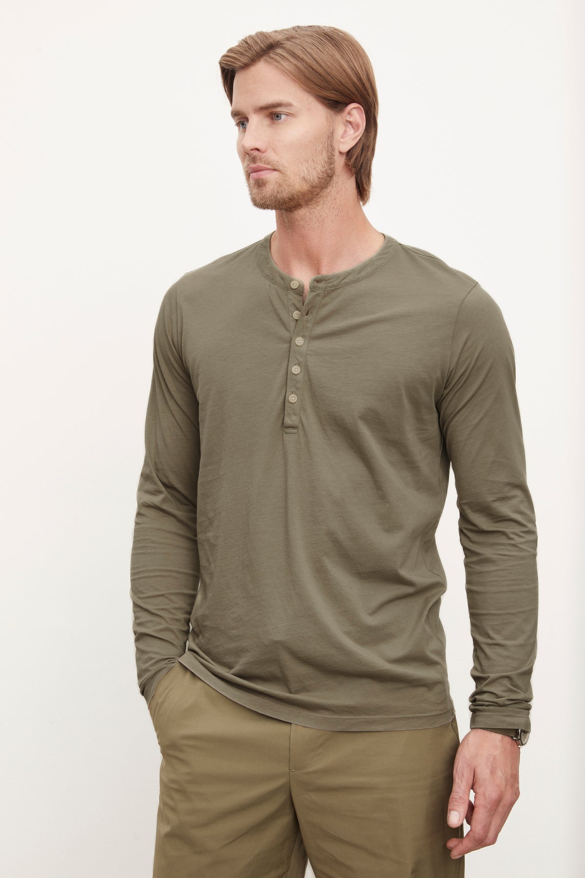 A man wearing a Velvet by Graham & Spencer ALVARO COTTON JERSEY HENLEY shirt paired with matching whisper knit pants, standing against a plain background.-36009056403649