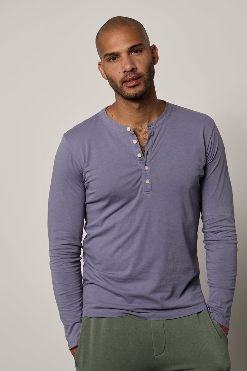 a man wearing a purple ALVARO COTTON JERSEY HENLEY henley t - shirt and green pants. Brand Name: Velvet by Graham & Spencer