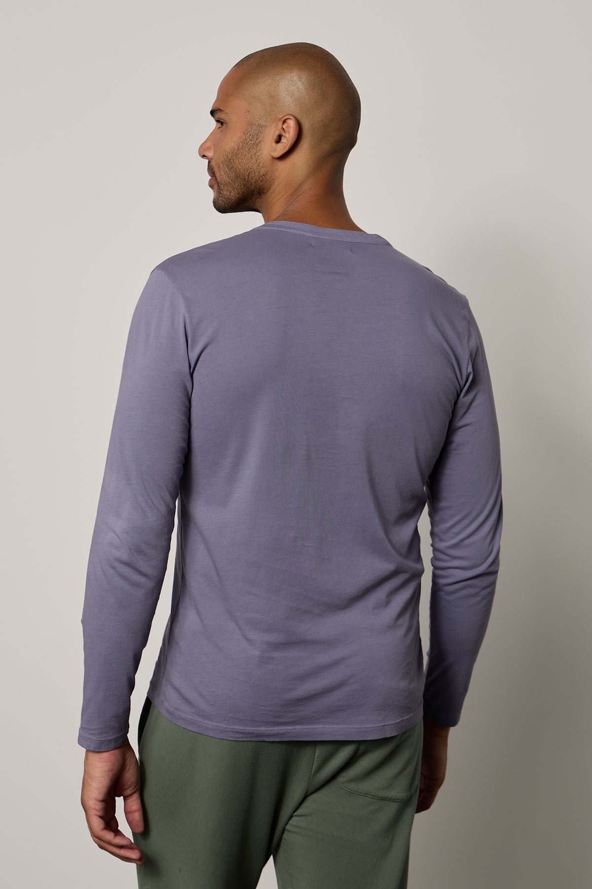   The back view of a man wearing an ALVARO COTTON JERSEY HENLEY t - shirt by Velvet by Graham & Spencer. 