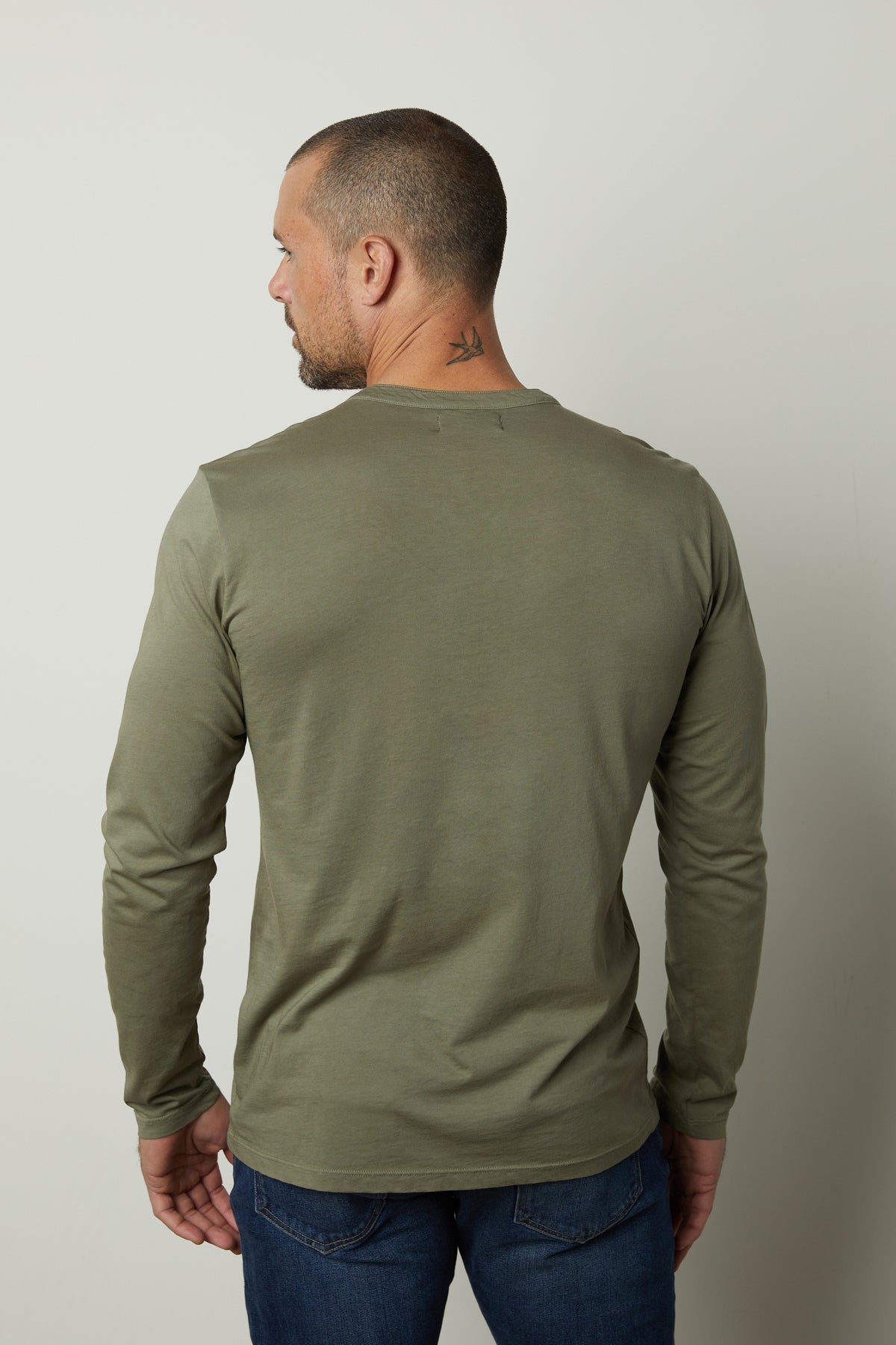 The back view of a man wearing a Velvet by Graham & Spencer ALVARO COTTON JERSEY HENLEY.-35782632800449