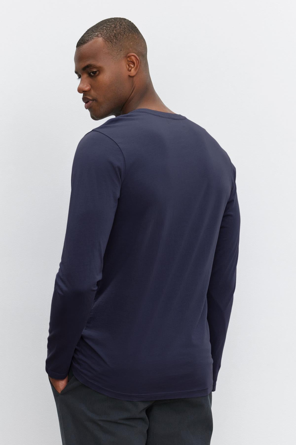 This man is wearing a Velvet by Graham & Spencer ALVARO COTTON JERSEY HENLEY, giving a glimpse of his back.-36273890590913