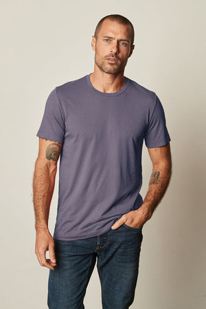 a man wearing a Velvet by Graham & Spencer HOWARD WHISPER CLASSIC CREW NECK TEE and jeans.