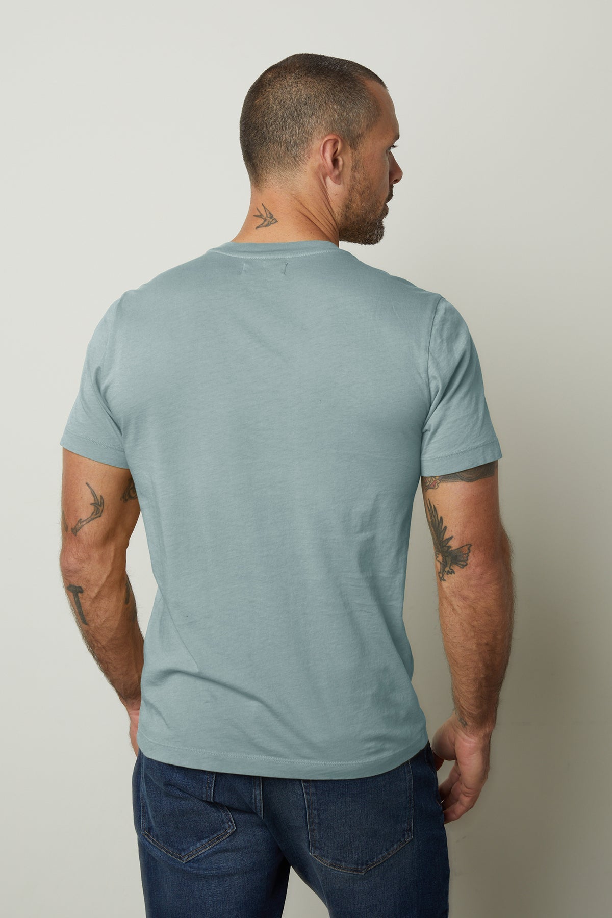 The back of a man wearing a Velvet by Graham & Spencer HOWARD WHISPER CLASSIC CREW NECK TEE with a vintage-feel softness.-35782849265857