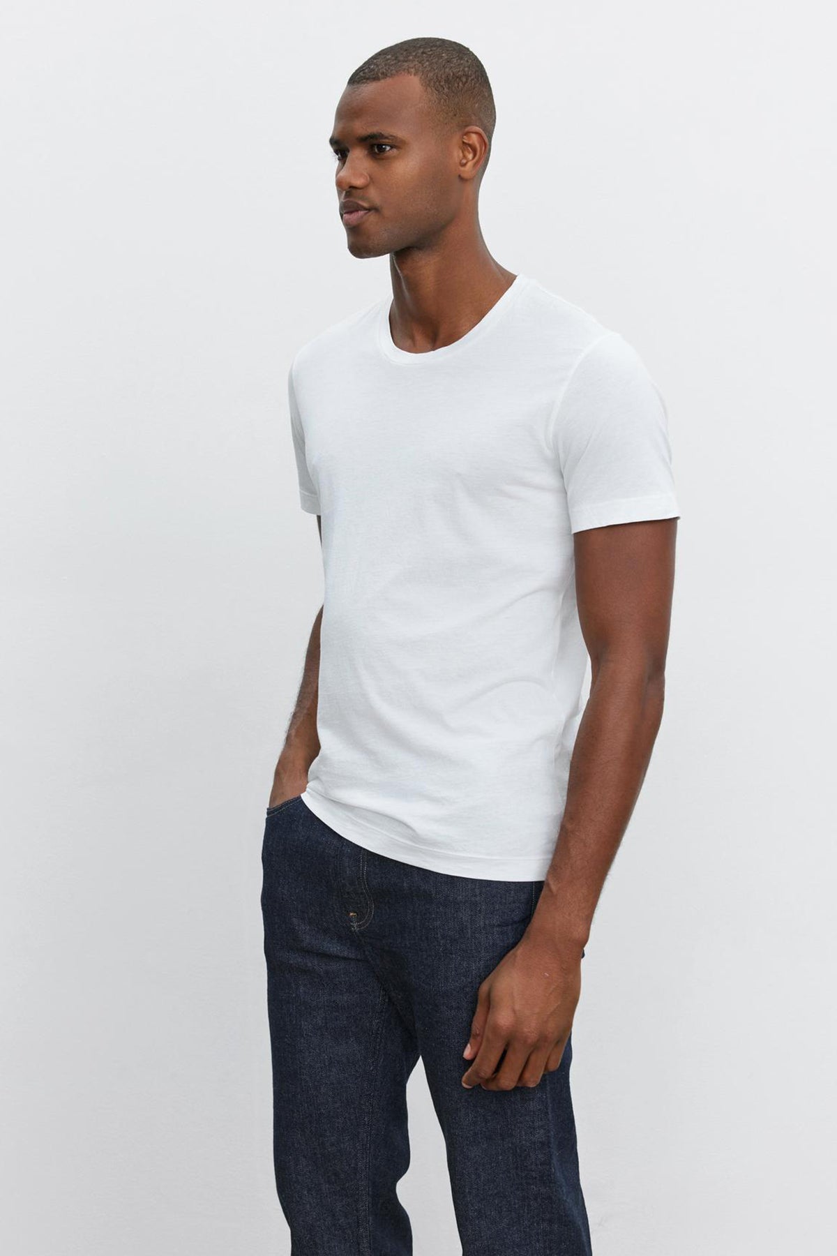 A man wearing a Velvet by Graham & Spencer HOWARD WHISPER CLASSIC CREW NECK TEE and jeans.-35867473215681