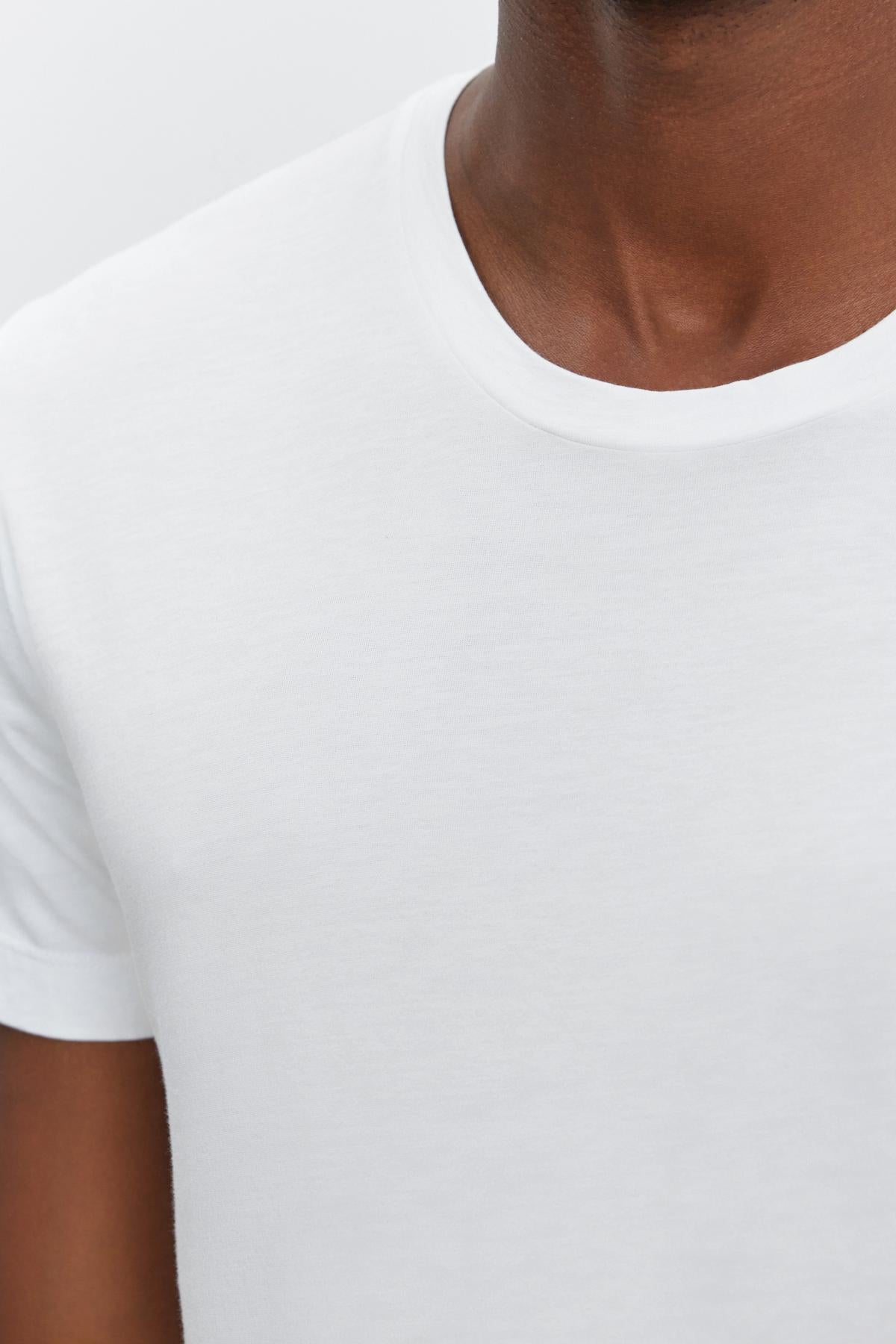 A close-up of a man wearing a HOWARD WHISPER CLASSIC CREW NECK TEE from Velvet by Graham & Spencer, with a flawless fit and lightweight cotton knit.-35867473281217