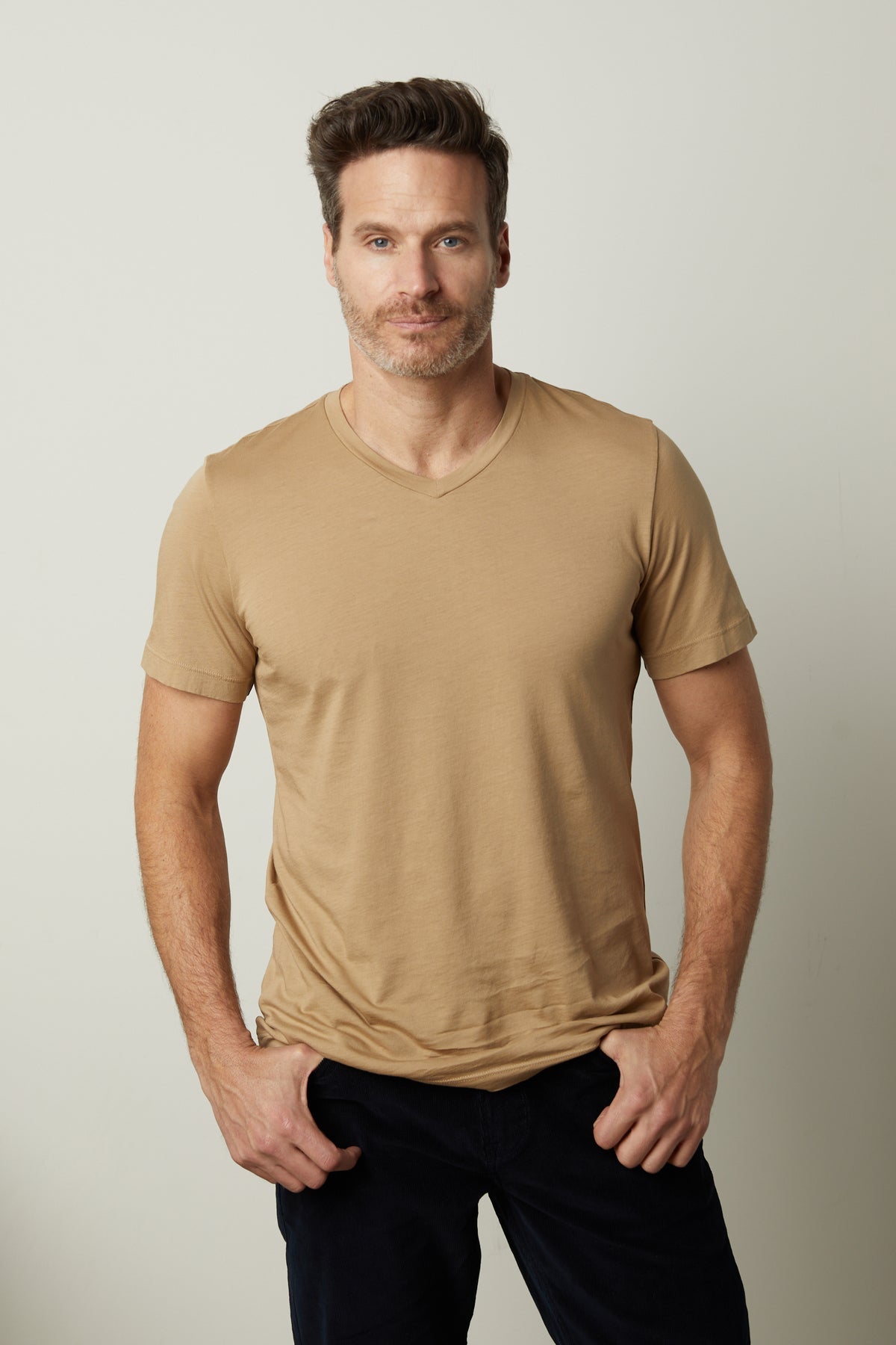   A silhouette of a man wearing a SAMSEN WHISPER CLASSIC V-NECK TEE created with whisper knit fabric, by Velvet by Graham & Spencer. 