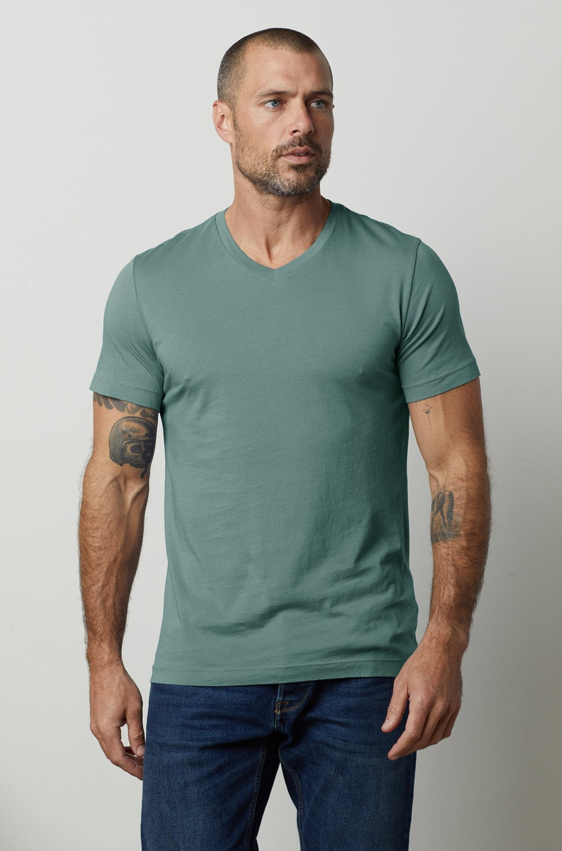 a man wearing a green Velvet by Graham & Spencer SAMSEN WHISPER CLASSIC V-NECK TEE.-26496252870849