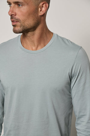 a man wearing a Velvet by Graham & Spencer SKEETER WHISPER CLASSIC CREW NECK TEE.