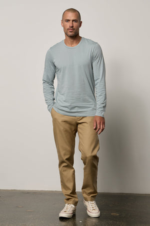 a man wearing a Velvet by Graham & Spencer SKEETER WHISPER CLASSIC CREW NECK TEE and khaki pants.