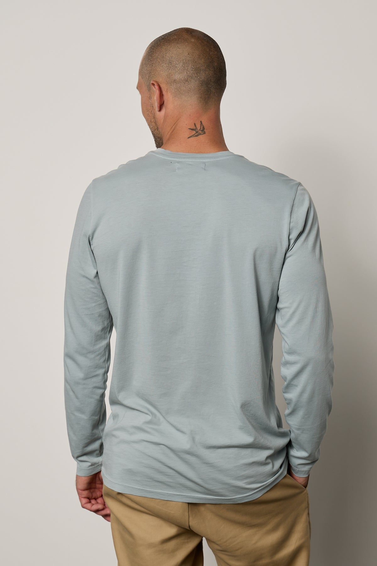   the back view of a man wearing a Velvet by Graham & Spencer SKEETER WHISPER CLASSIC CREW NECK TEE. 