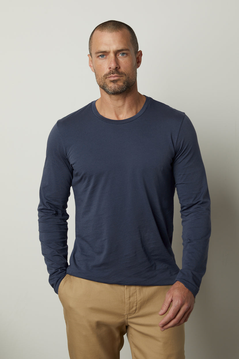 A man wearing a Velvet by Graham & Spencer SKEETER WHISPER CLASSIC CREW NECK TEE for cool months.