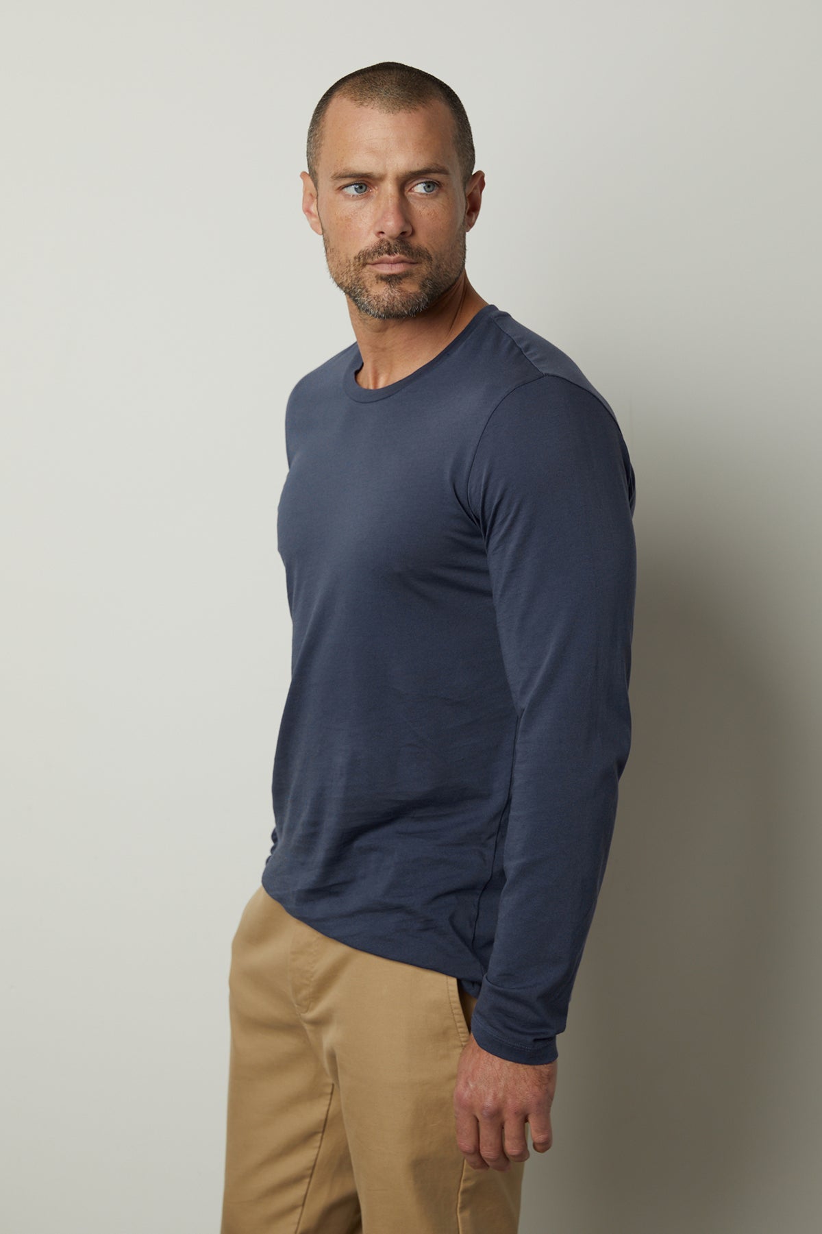 A man wearing a Velvet by Graham & Spencer Skeeter Whisper Classic Crew Neck Tee, a garment-dyed cotton knit.-35783155318977