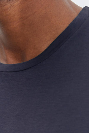 Close-up of a person wearing a Velvet by Graham & Spencer SKEETER WHISPER CLASSIC CREW NECK TEE, focusing on the collar area and part of the neck.