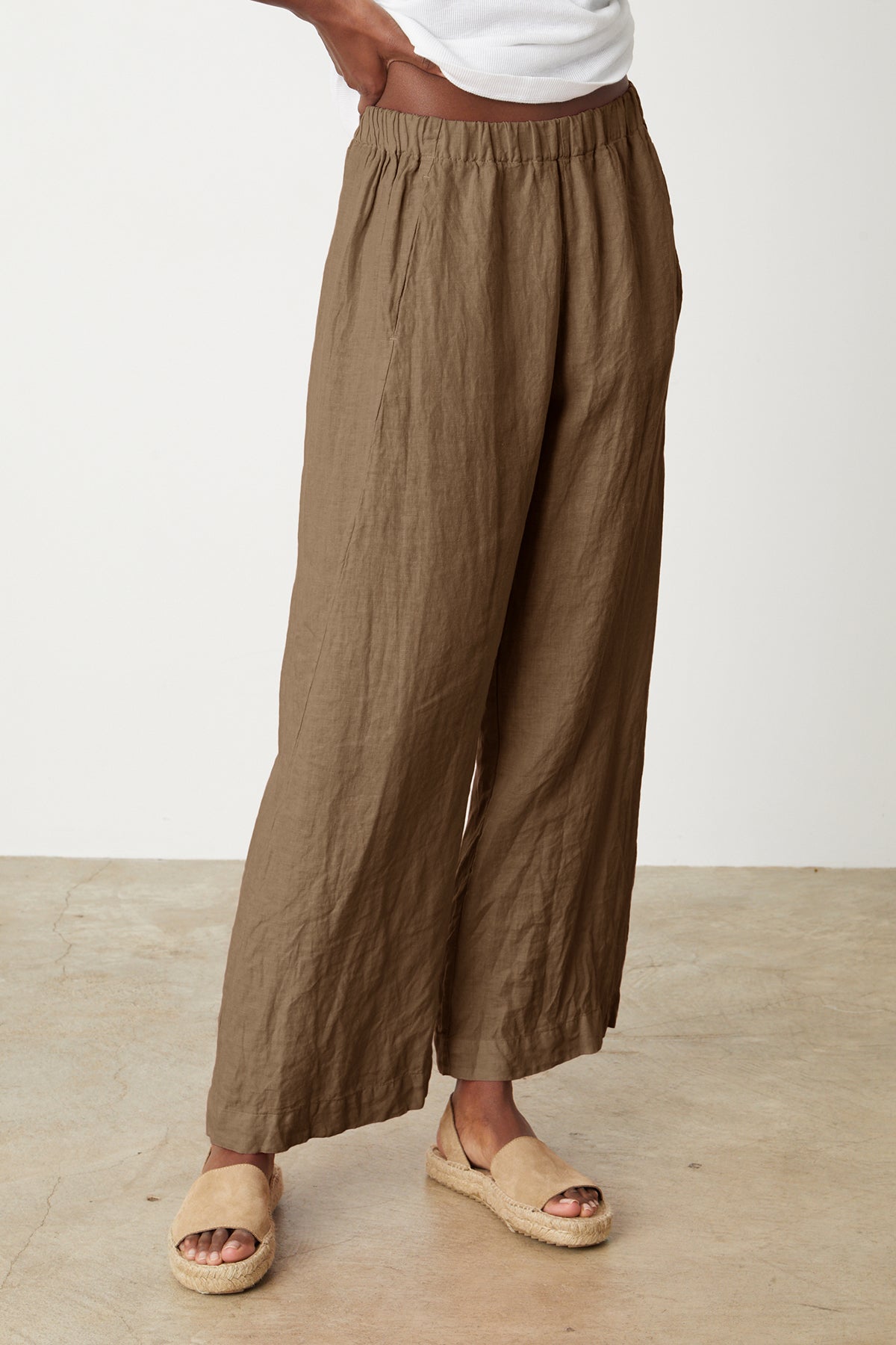   A woman wearing the LOLA LINEN PANT by Velvet by Graham & Spencer with an elastic waist. 