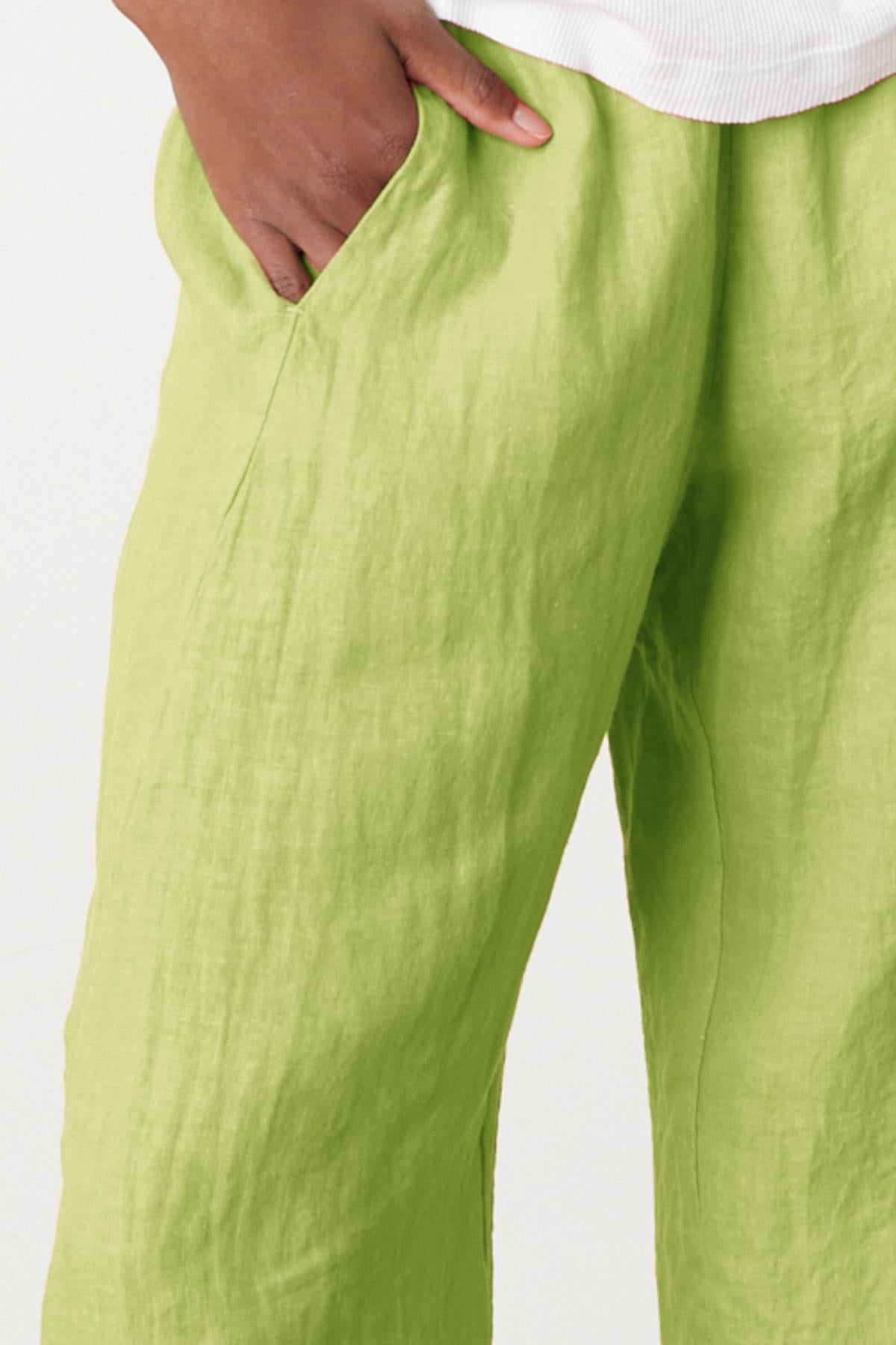   Lola pant in kiwi green colored linen close up front and pocket detail 
