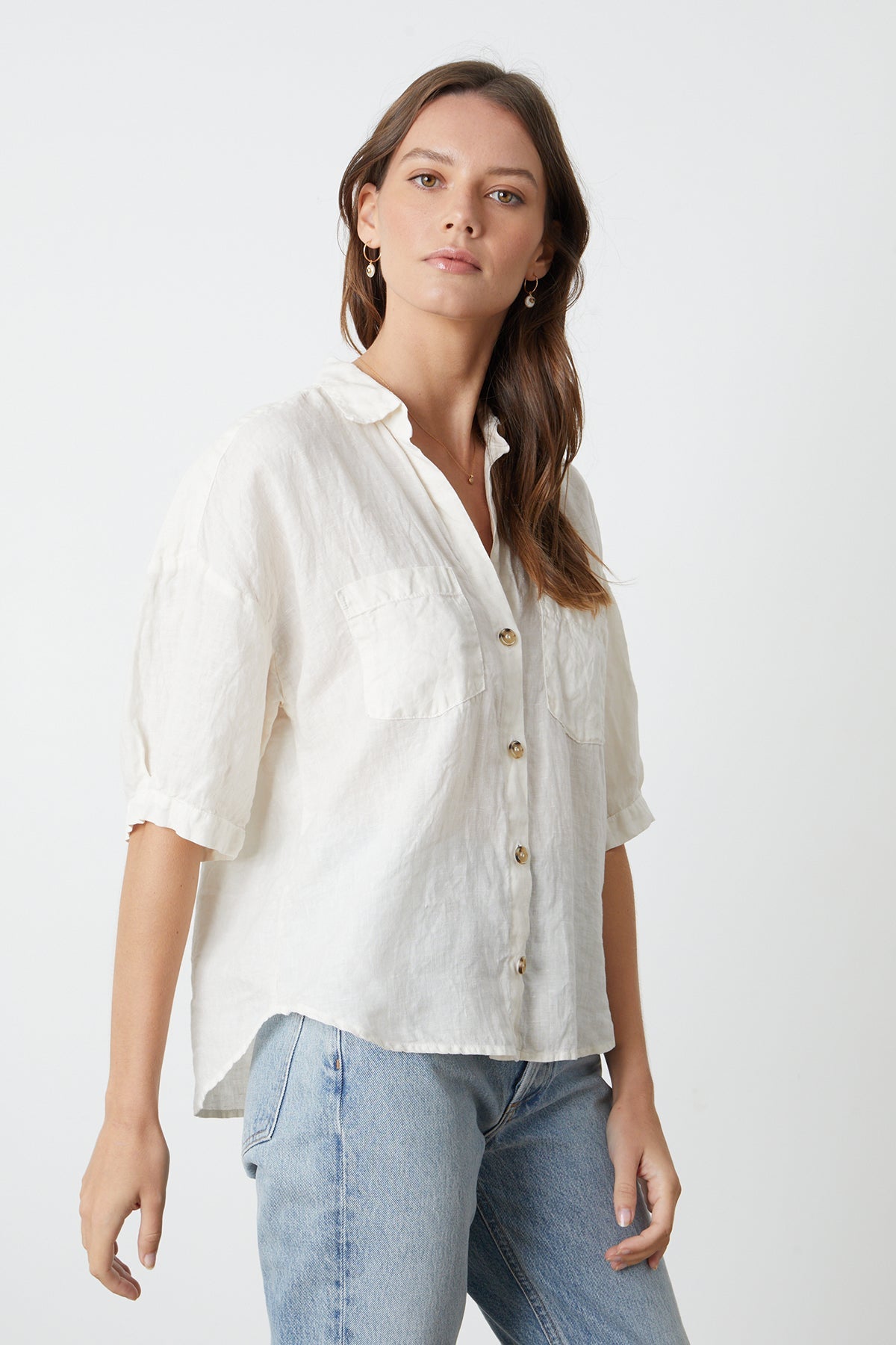 The model is wearing a Velvet by Graham & Spencer MARIA LINEN BUTTON-UP SHIRT and jeans.-26715366949057