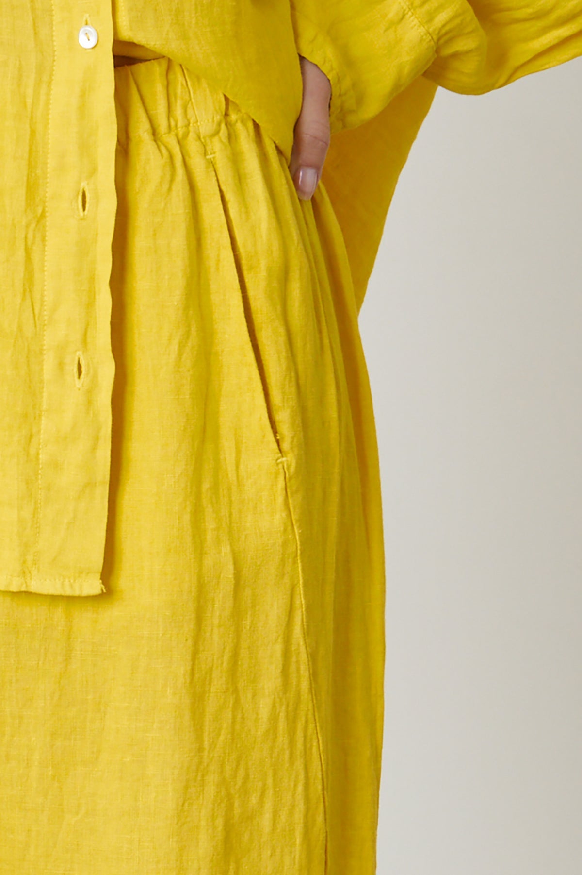  Lola pant in bright yellow sun colored linen close up detail of hip and pocket front 