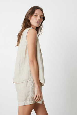 The model is wearing a sleeveless Velvet by Graham & Spencer linen top and shorts.