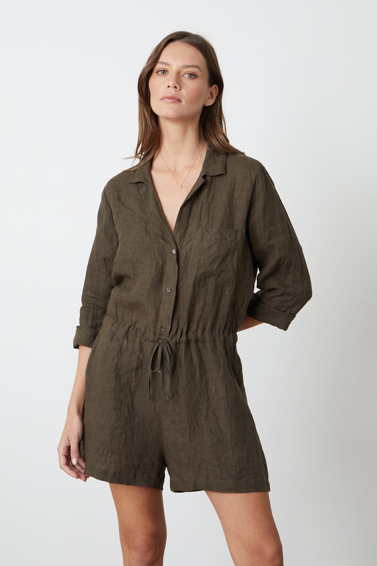 a woman wearing a green RUTH LINEN ROMPER by Velvet by Graham & Spencer.-26327261282497